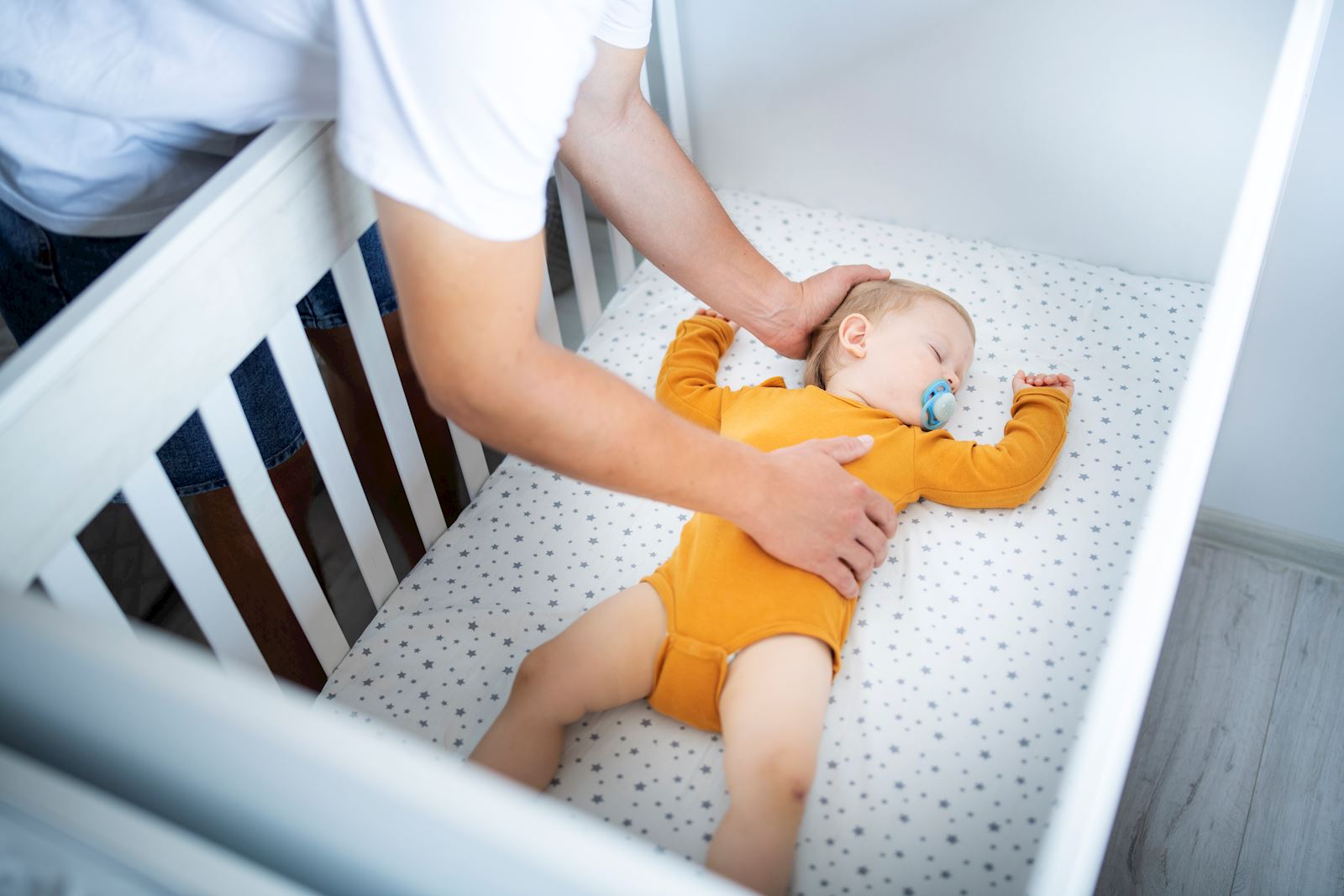 mom checking on her baby in crib