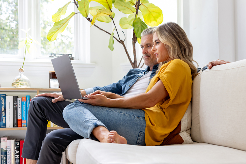 Couple doing research on laptop