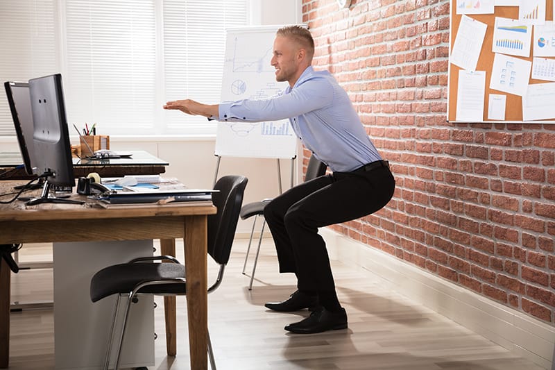 Workout While Working: 7 Exercises You Can Do at Your Desk