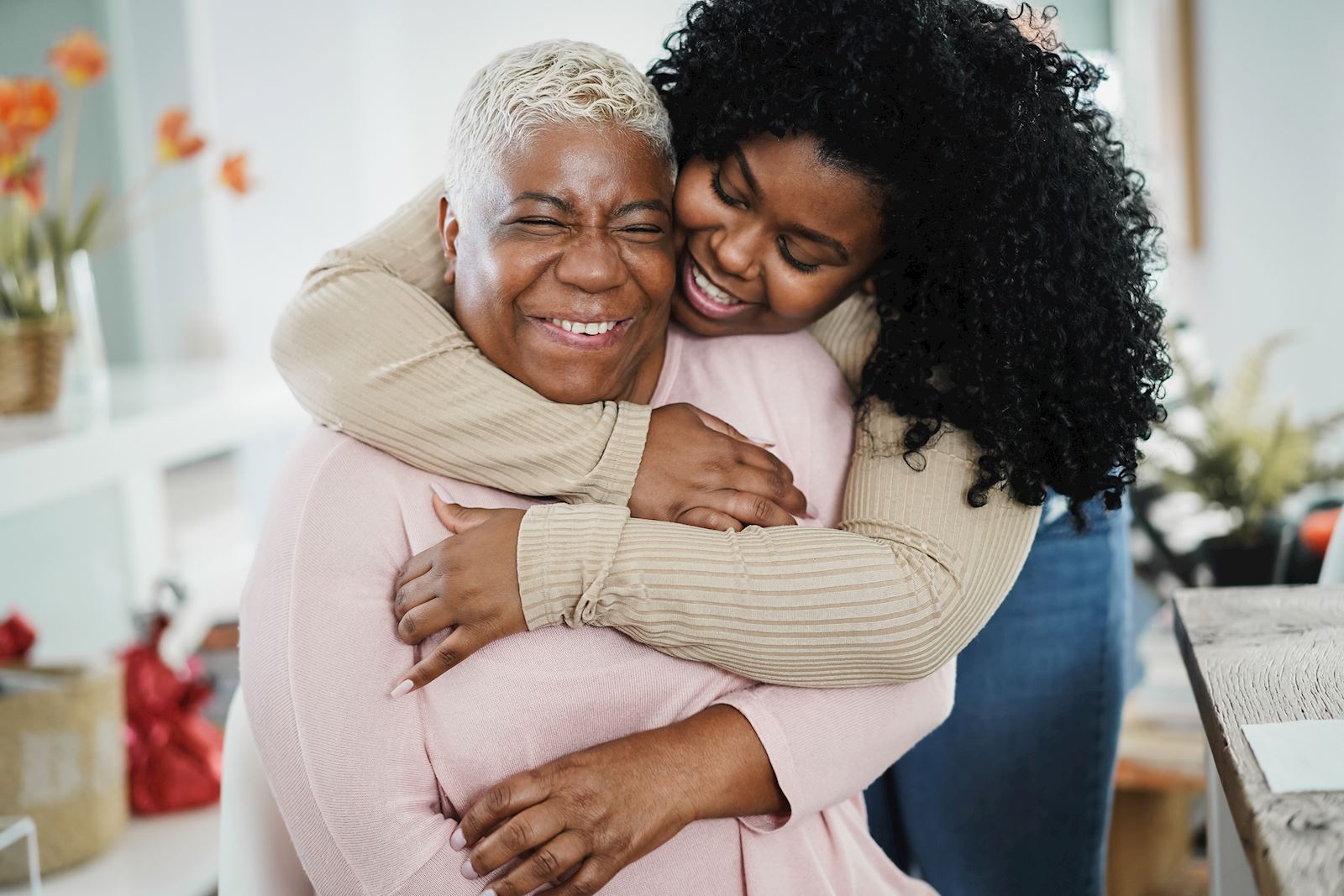 younger woman hugs older woman