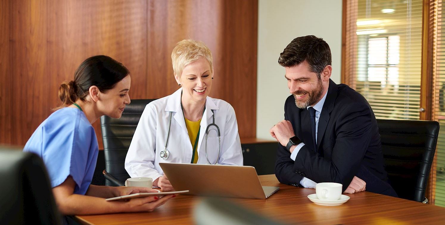 businessman meeting with doctor and nurse
