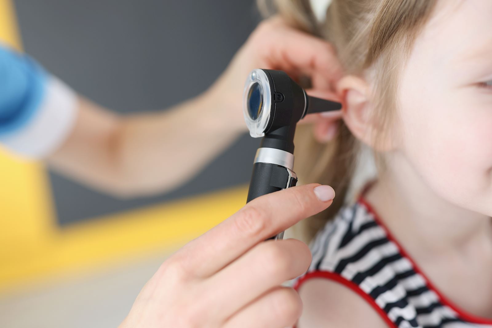 doctor using otoscope in a child's ear