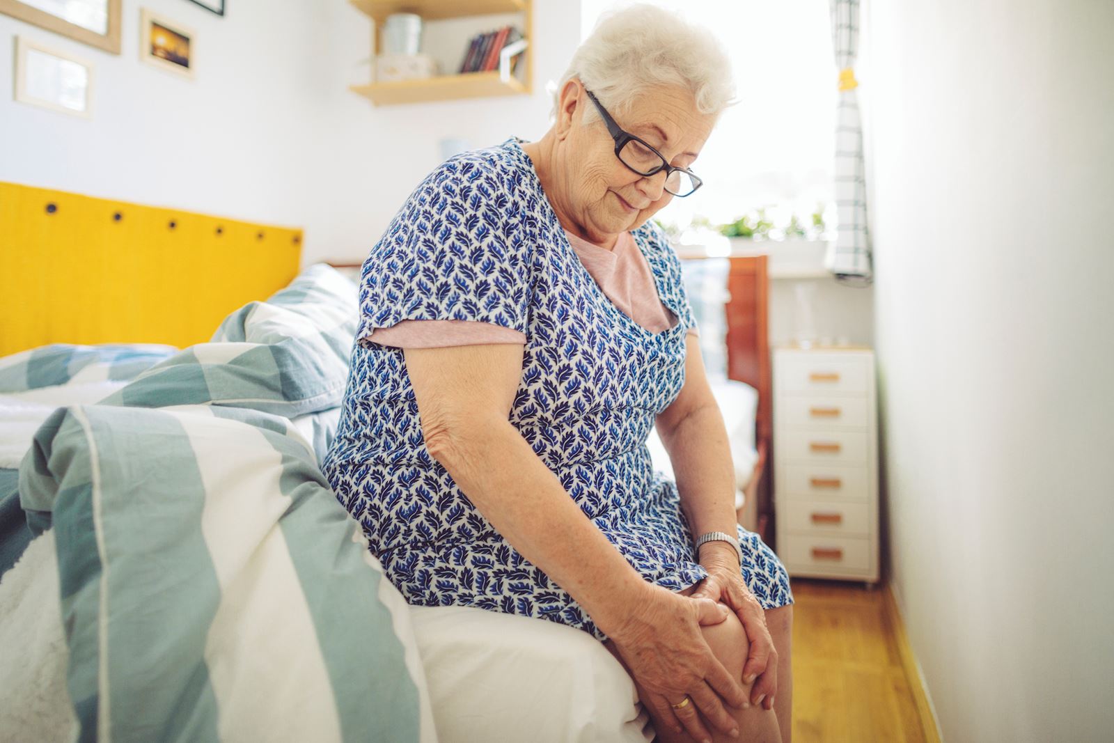 older woman holding knee