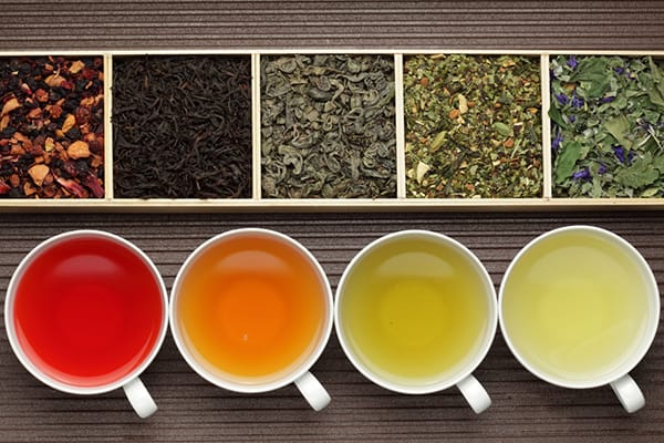 array of different teas and tea leaves on a table