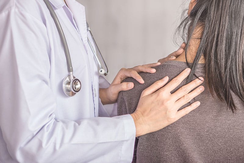 doctor checks out woman's neck