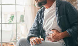 man holding his abdomen in pain